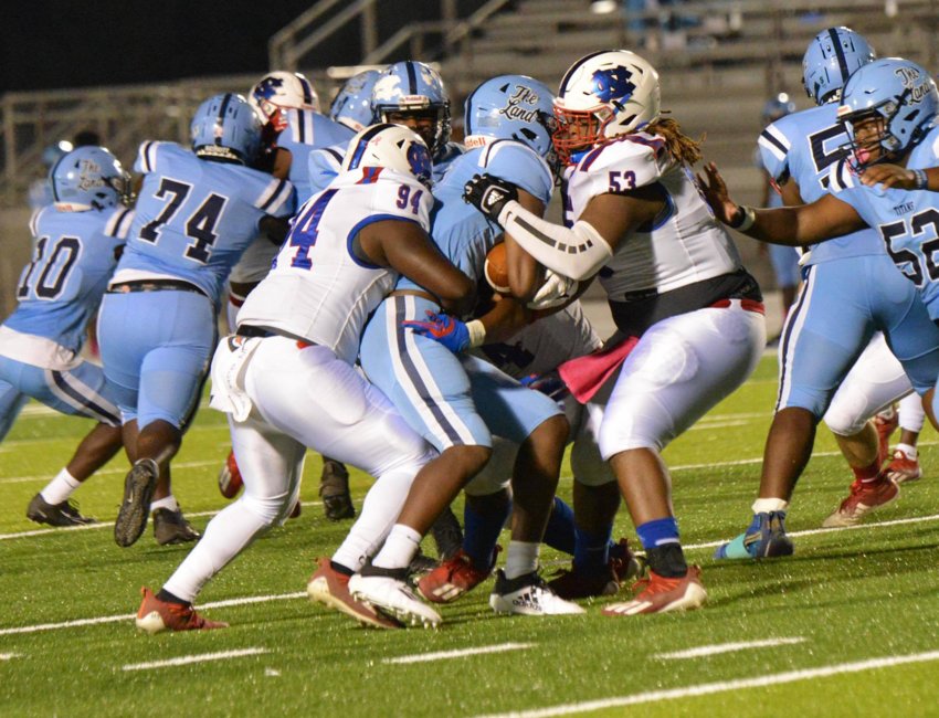 Neshoba Central defenders Demarkez West and Maxton Woodward bring down a Ridgeland ball carrier during Friday’s game.